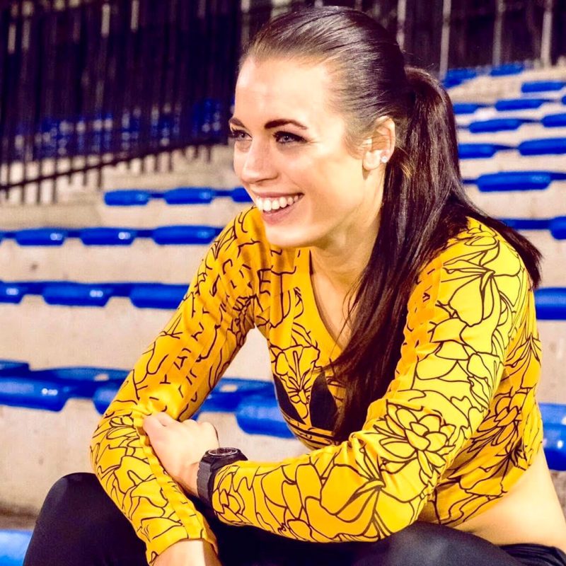 Elana Withnall-Dickson sitting in stadium in training gear