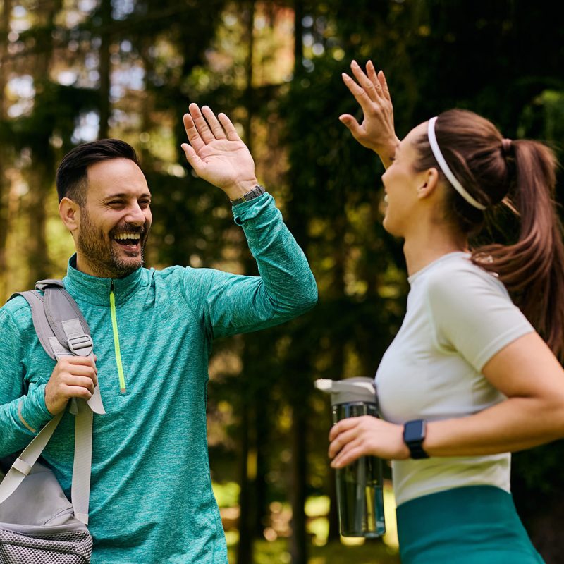 Man and woman in gym gear give each other high-five